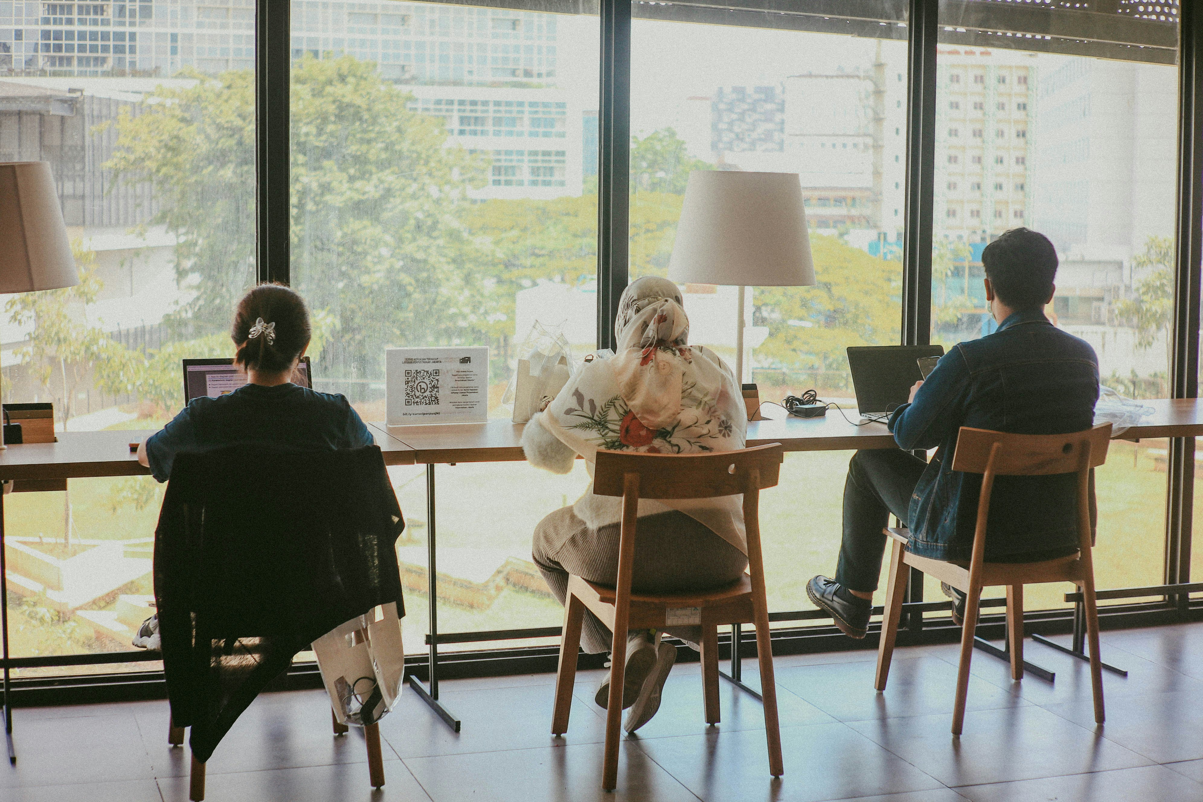 three people working in their laptops