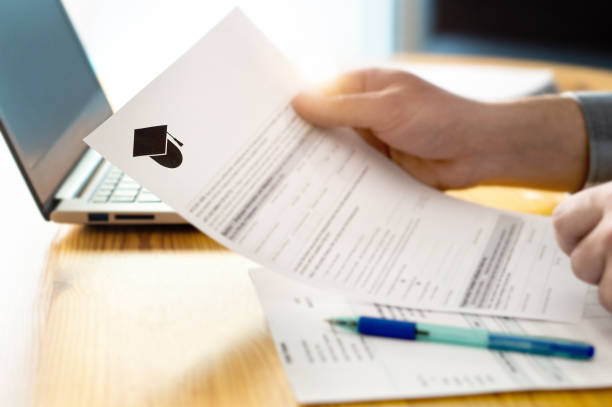 Man reading college or university application or document from school. College acceptance letter or student loan paper. stock photo